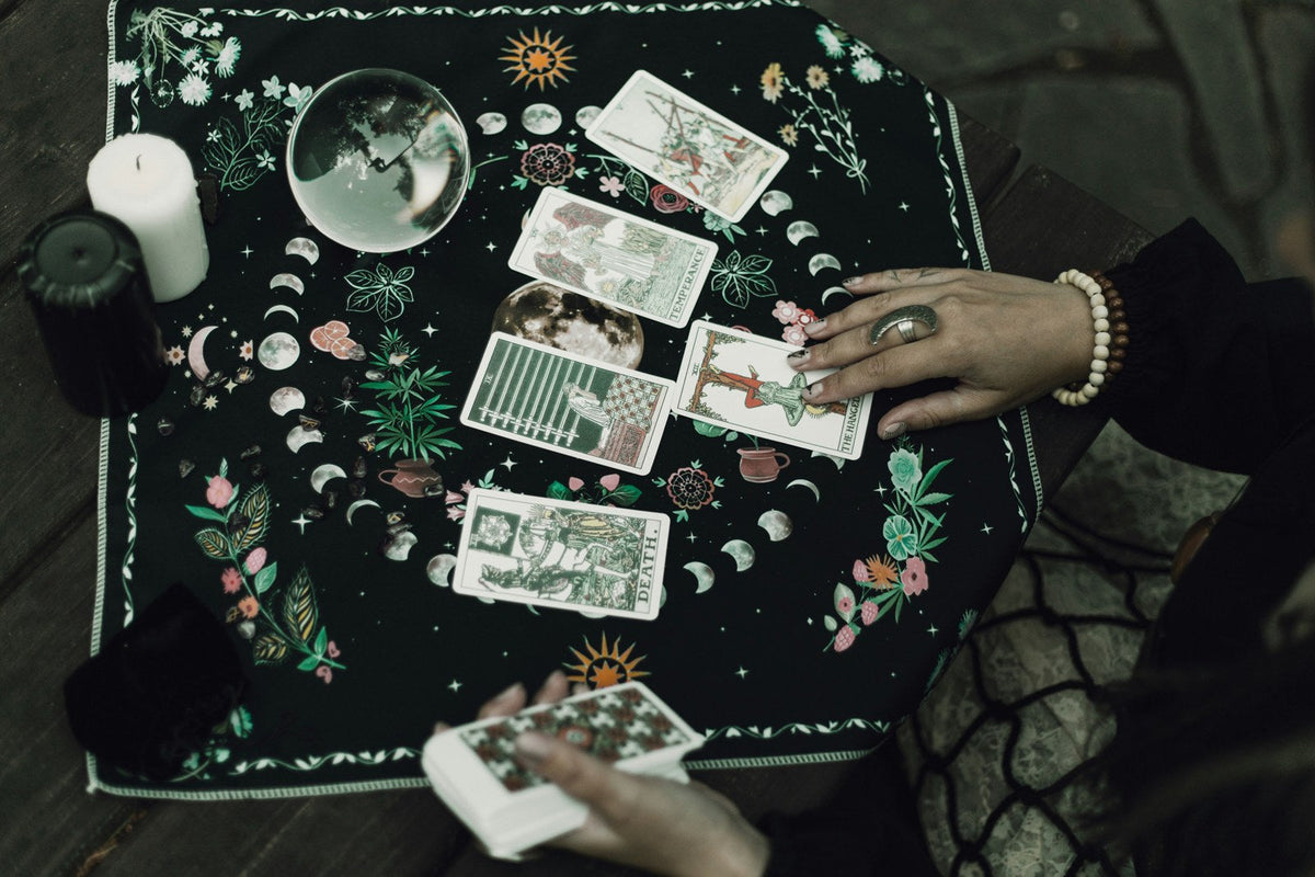 Tarot cards and crystals representing the RESONATE Tarot Reading Journal PDF download